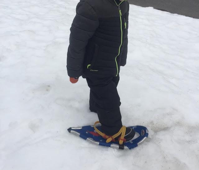 kindergartener on snowshoes to learn how rabbits move